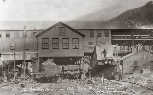 View of factory building and machines operated by workers