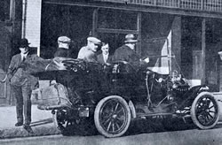 Men pose in a car